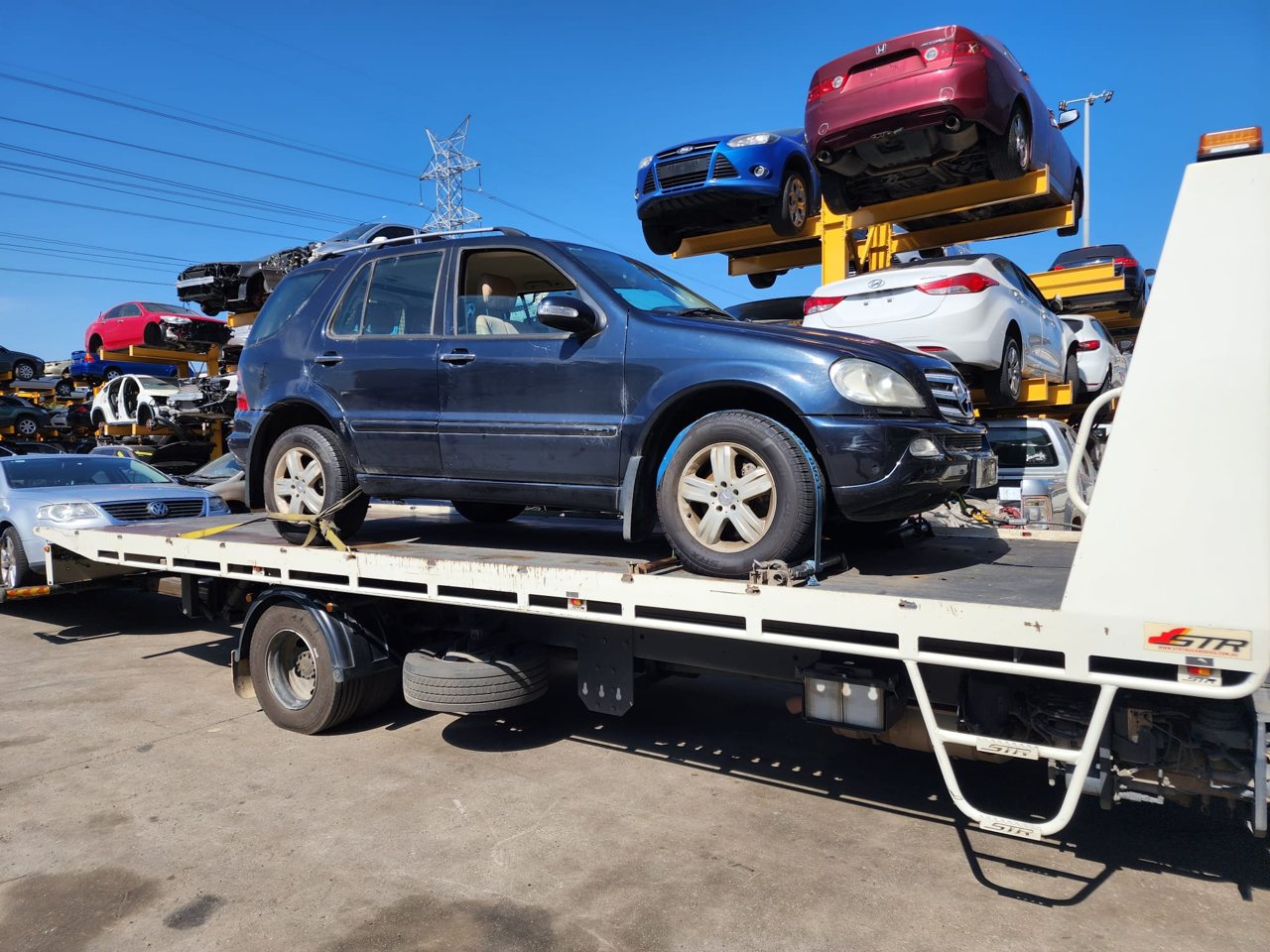 Blue SUV loaded on a transporter
