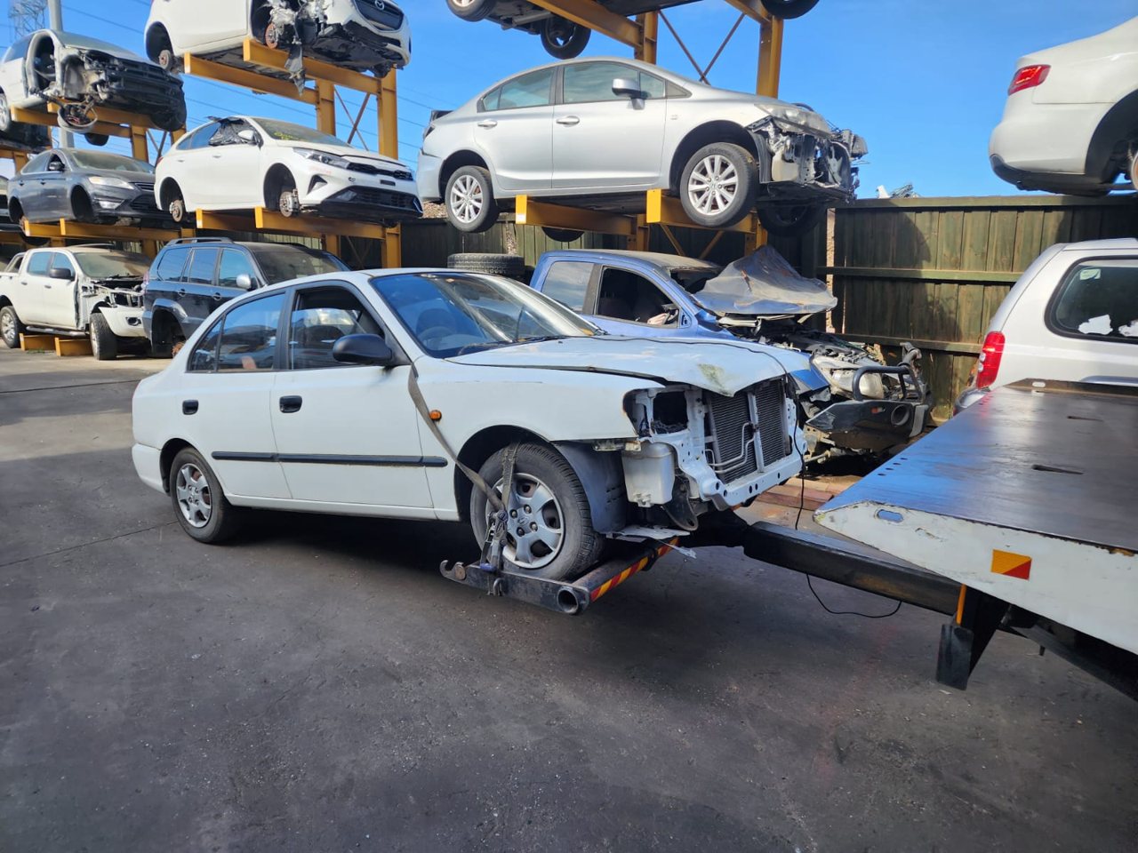 White hatchback in a vehicle yard