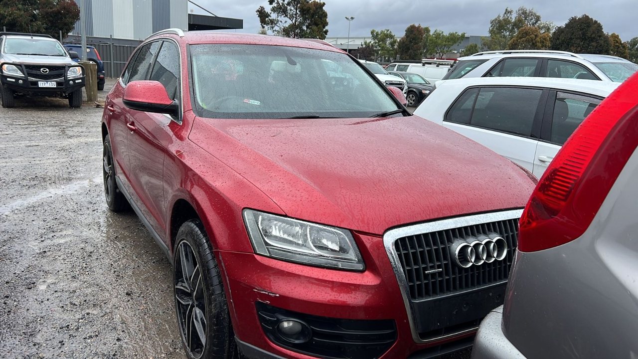 Red SUV parked in a vehicle yard