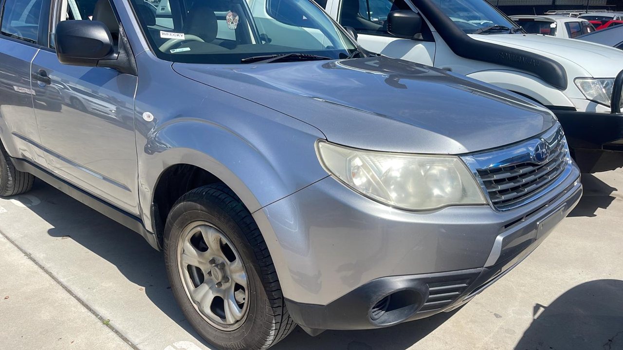 Silver SUV parked beside other vehicles