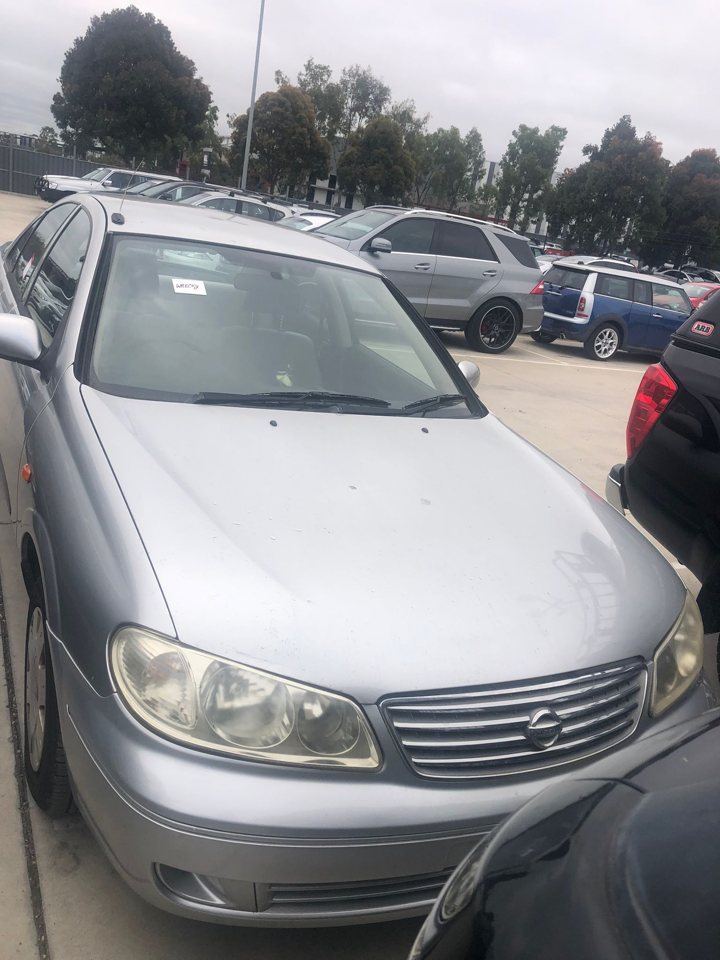 Silver sedan parked beside other cars