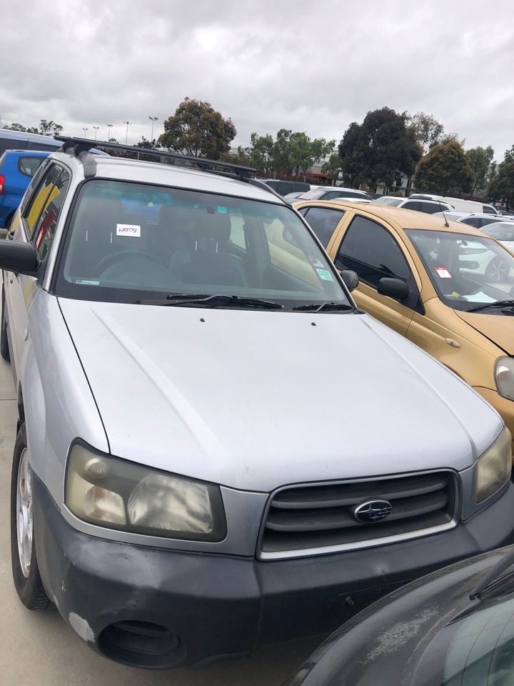 Silver sedan in a vehicle yard