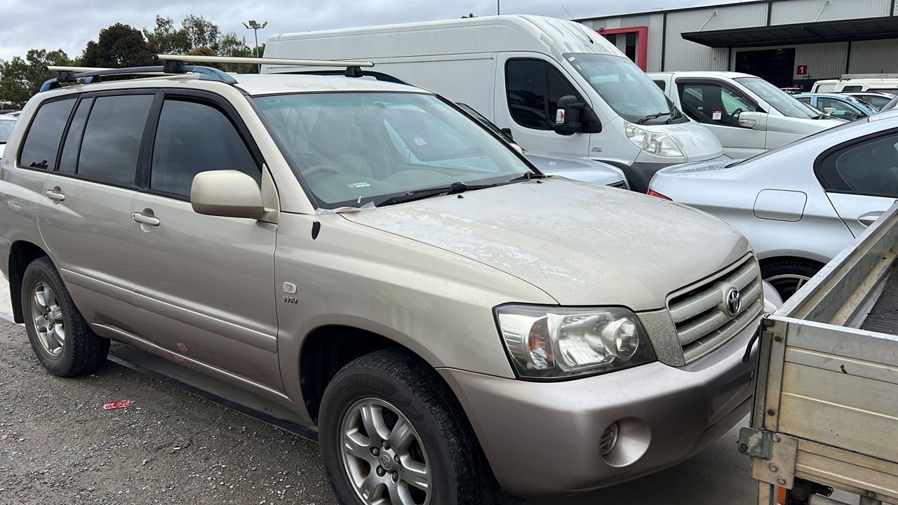Beige SUV in a vehicle yard