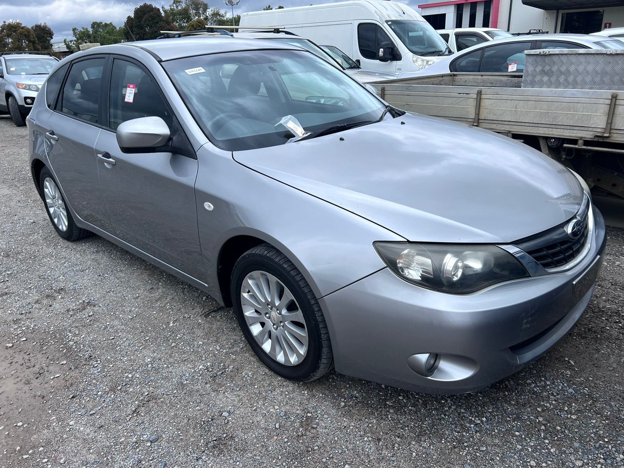 Silver sedan parked alongside other cars