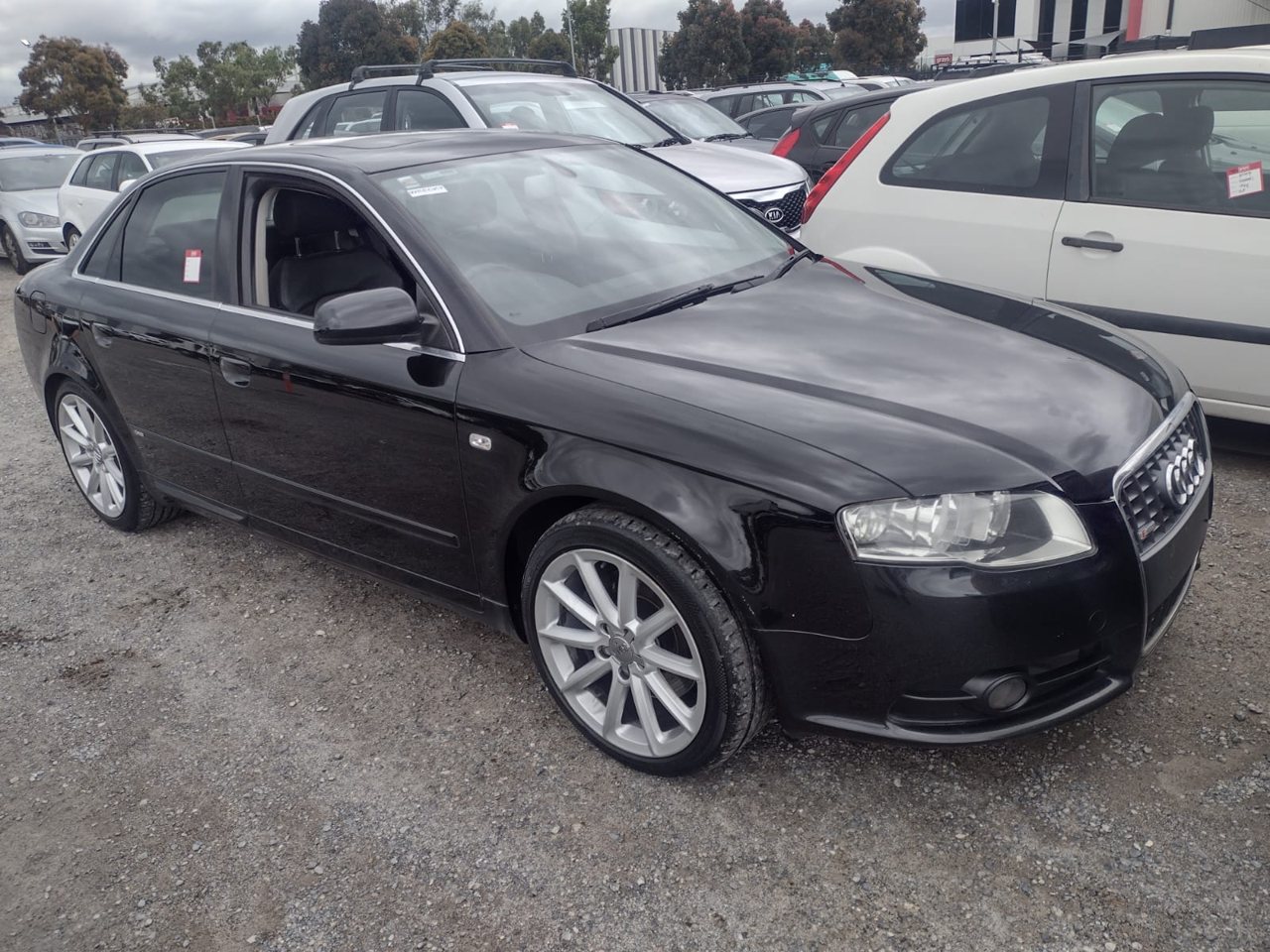 Black sedan viewed from the front side