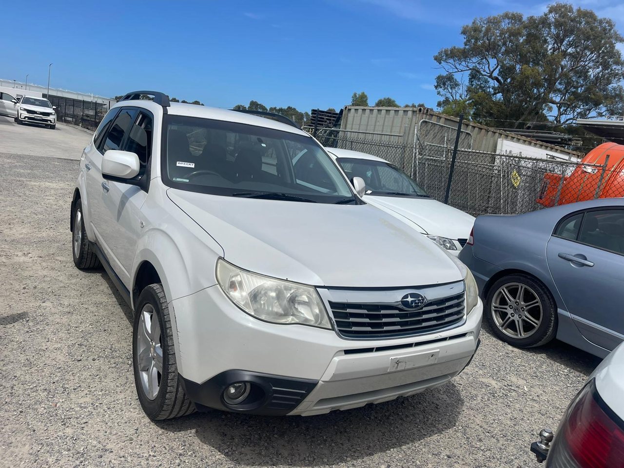 Silver SUV parked alongside other cars