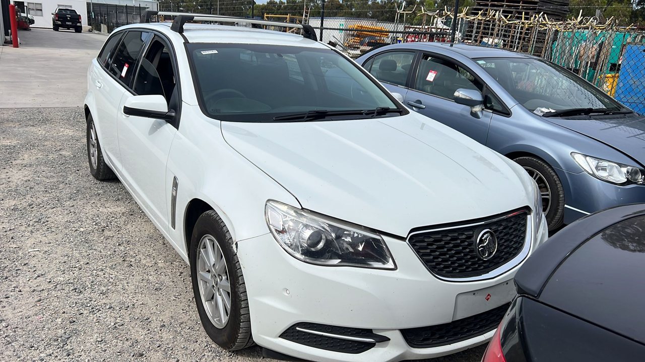 White sedan in a vehicle yard