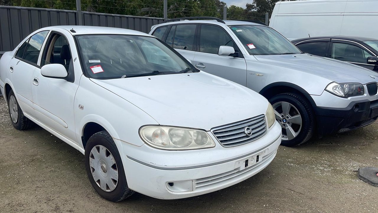 White sedan in a vehicle yard