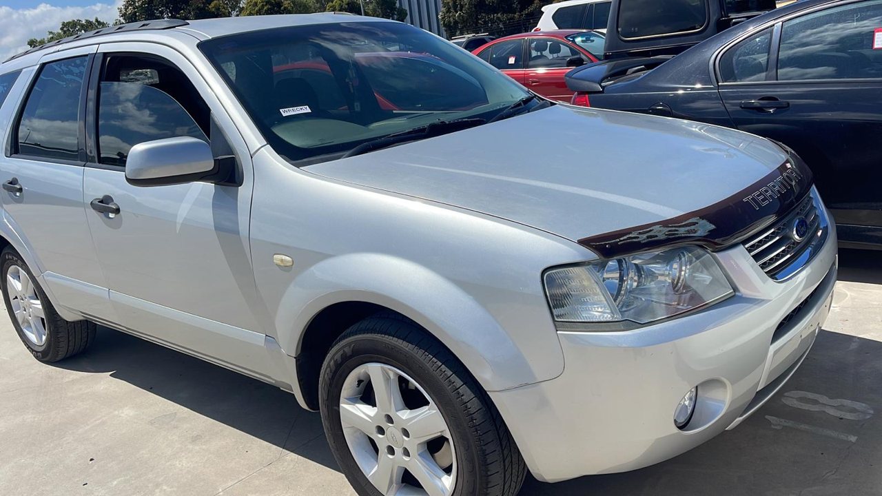 White SUV parked alongside other vehicles