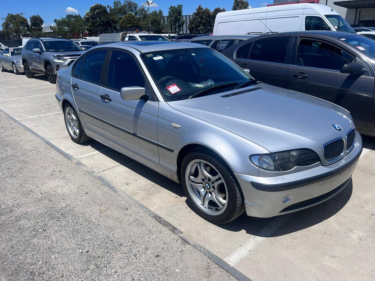 Silver sedan parked in a vehicle yard
